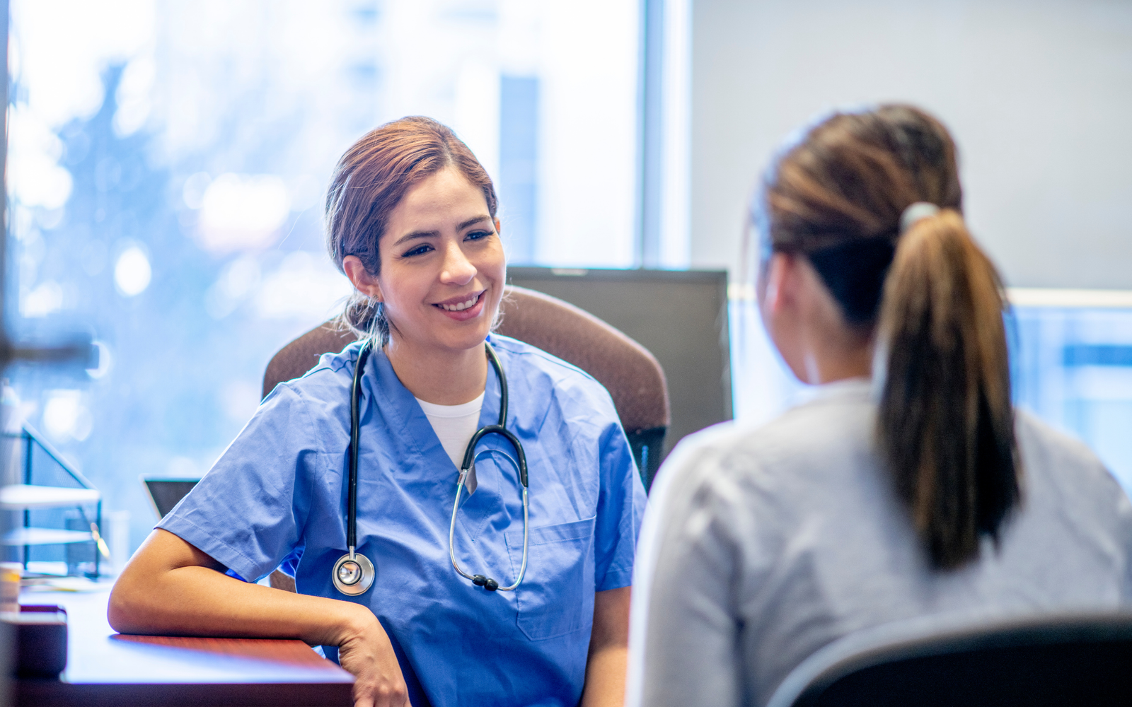 Professional nurse consultation session for NCLEX-RN coaching at Medcity International Academy, featuring a healthcare professional in scrubs guiding a student, representing international nursing exam preparation, clinical communication skills, and global healthcare career opportunities.